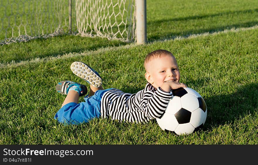 Happy little boy with his soccer ball