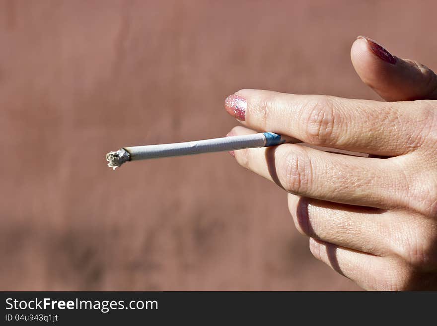 Cigaret in hands of the silly woman. Cigaret in hands of the silly woman