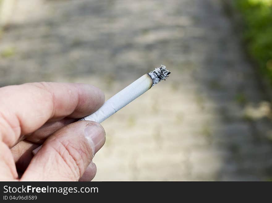 Cigaret in hands of the silly man. Cigaret in hands of the silly man