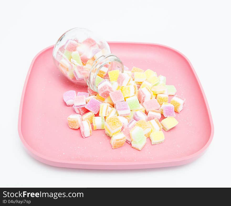 Colorful of jelly and sugar on pink plate.