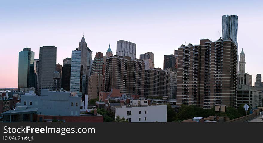 Panoramic view of Manhattan, New York, at twilight, from Brooklyn Bridge to Financial District. Panoramic view of Manhattan, New York, at twilight, from Brooklyn Bridge to Financial District