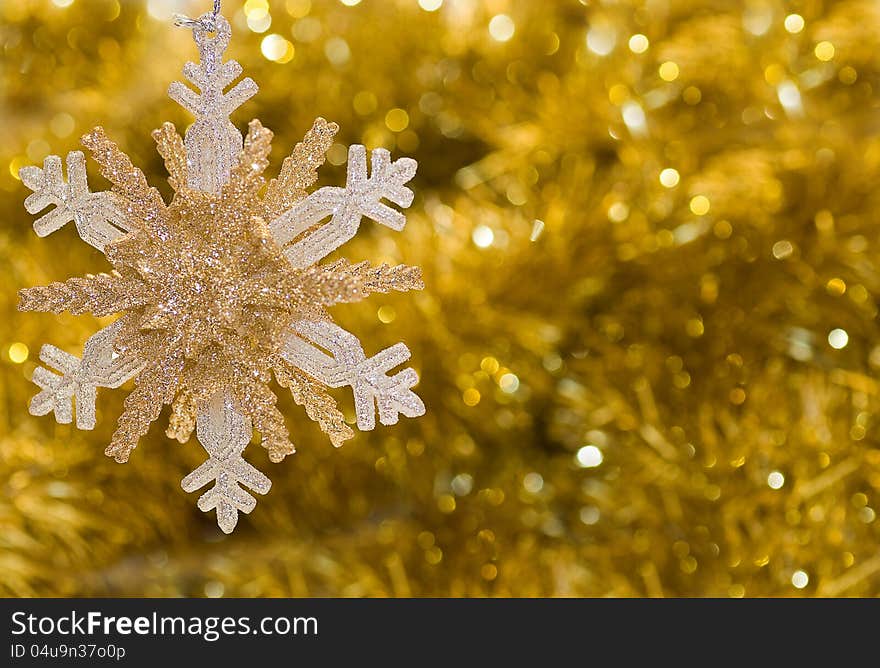 On a gold background shiny big beautiful snowflake. On a gold background shiny big beautiful snowflake