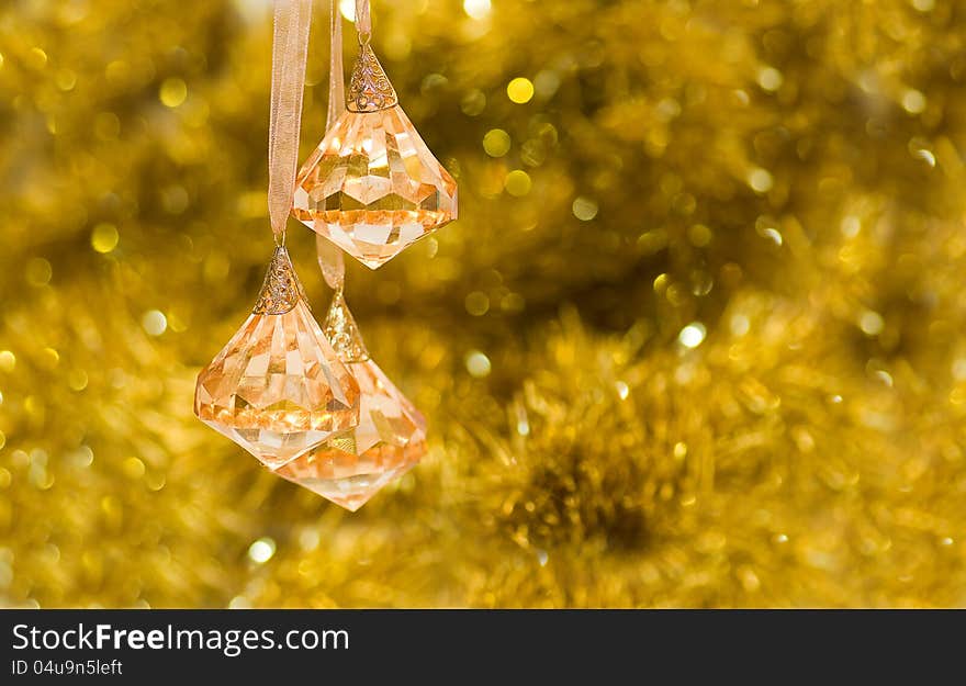 On a gold background brilliant yellow transparent bells. On a gold background brilliant yellow transparent bells