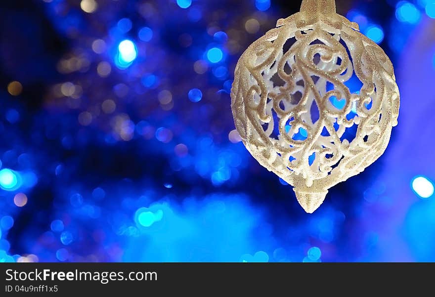 On a blue background with a large white lights Christmas Toy. On a blue background with a large white lights Christmas Toy