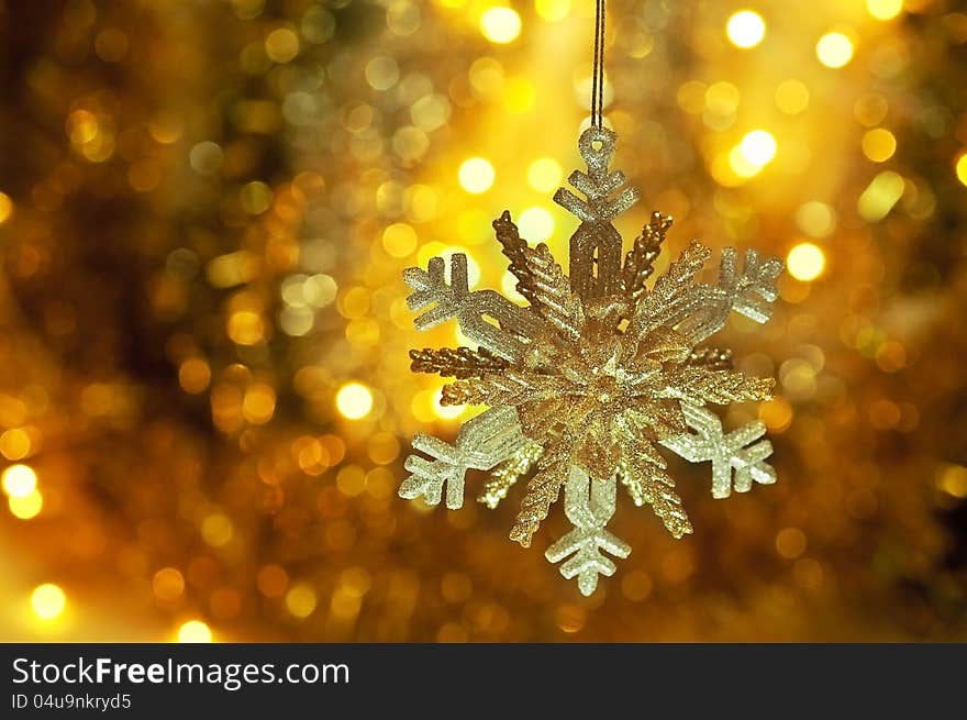 On a gold background shiny big beautiful snowflake. On a gold background shiny big beautiful snowflake