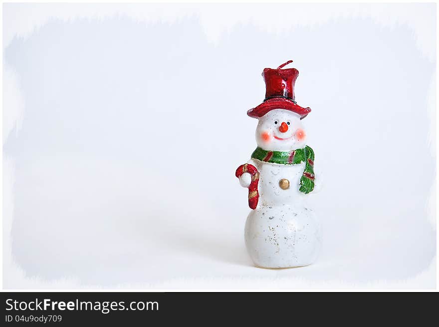 Snowman on a white background in a red cap with a green scarf. Snowman on a white background in a red cap with a green scarf