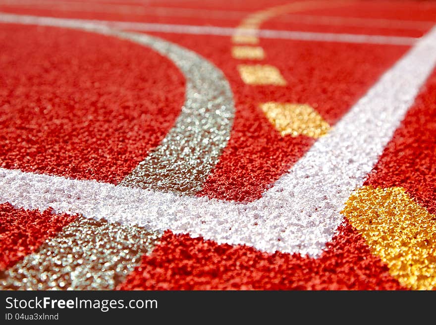 rnA white line on an red sports field. rnA white line on an red sports field.