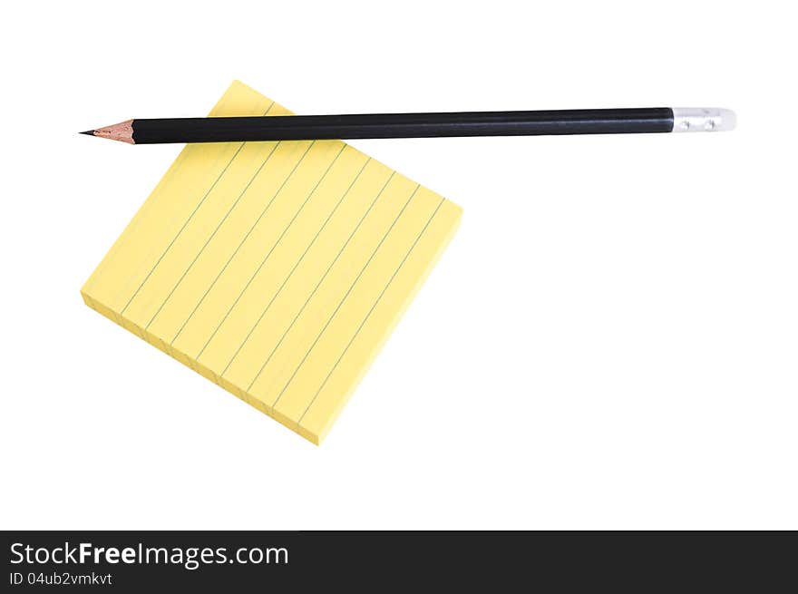 Sharp black pencil on a pack of yellow lined post-it notes. Sharp black pencil on a pack of yellow lined post-it notes