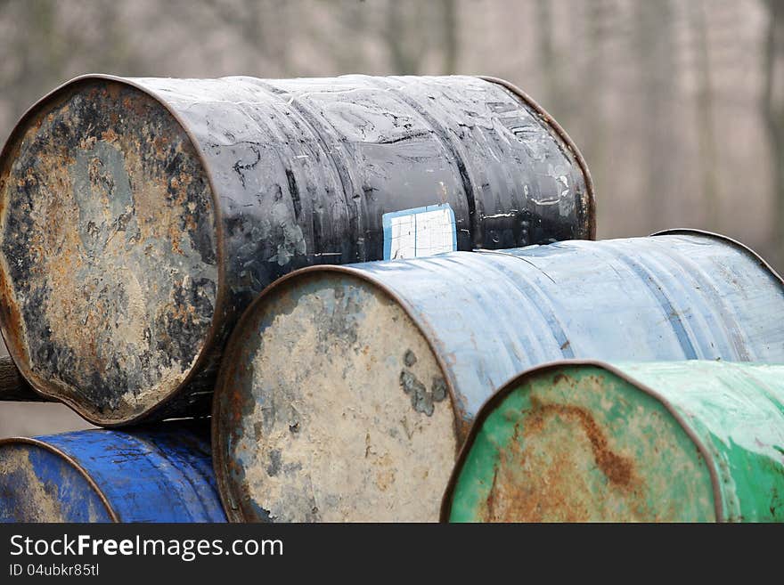 Colorful rusty metal barrel in the wood. Colorful rusty metal barrel in the wood