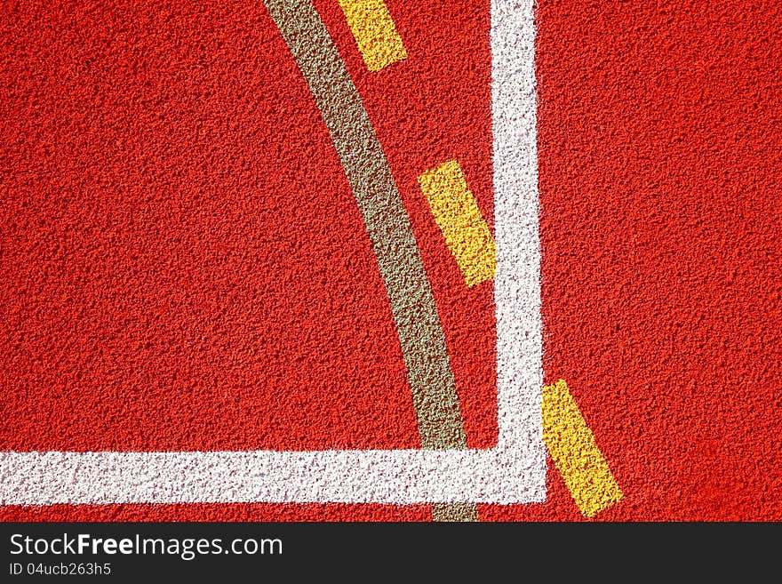 A white line on an red sports field. A white line on an red sports field.