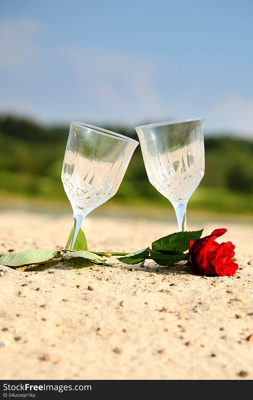 Empty pair glass on sand beach