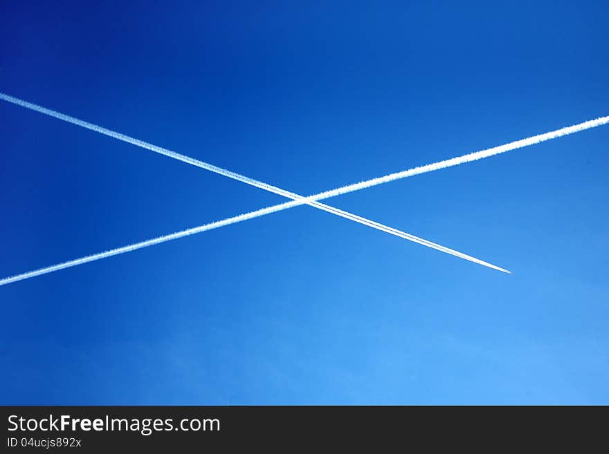 White crossing trace of airplanes in blue sky. White crossing trace of airplanes in blue sky