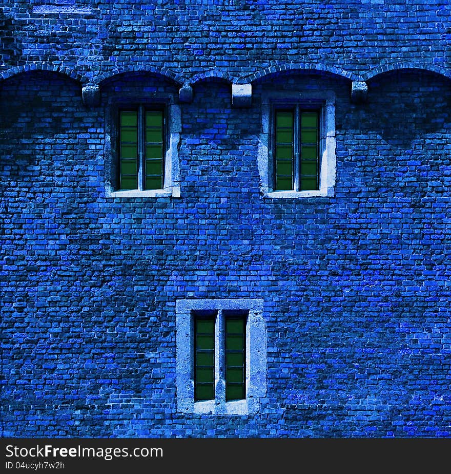 Background or texture of a blue brick wall with windows