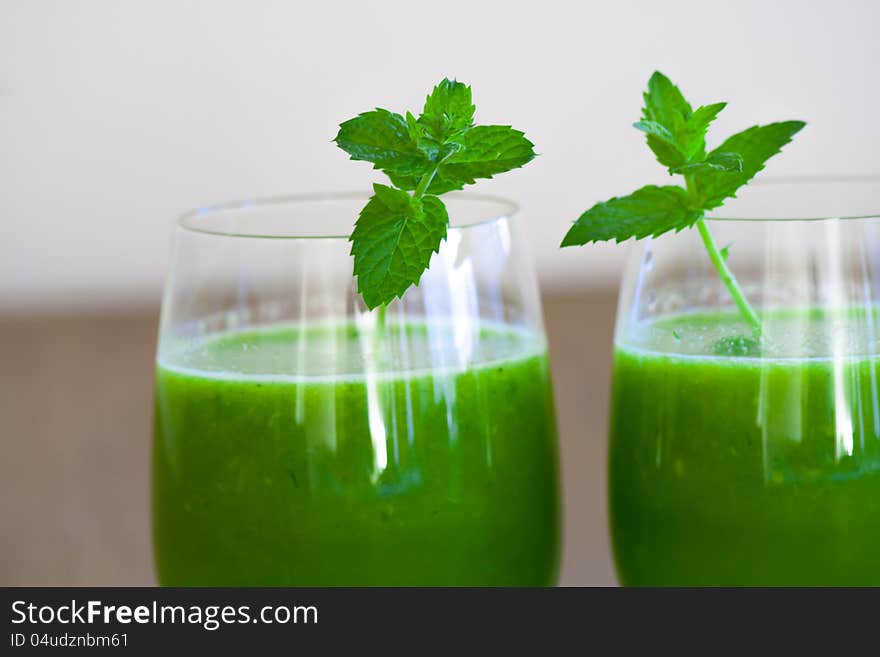 Healthy wheatgrass juice with orange and mint