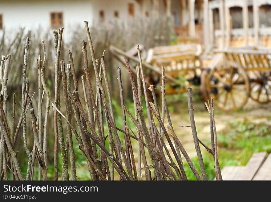 Rural courtyard through a fence of rods