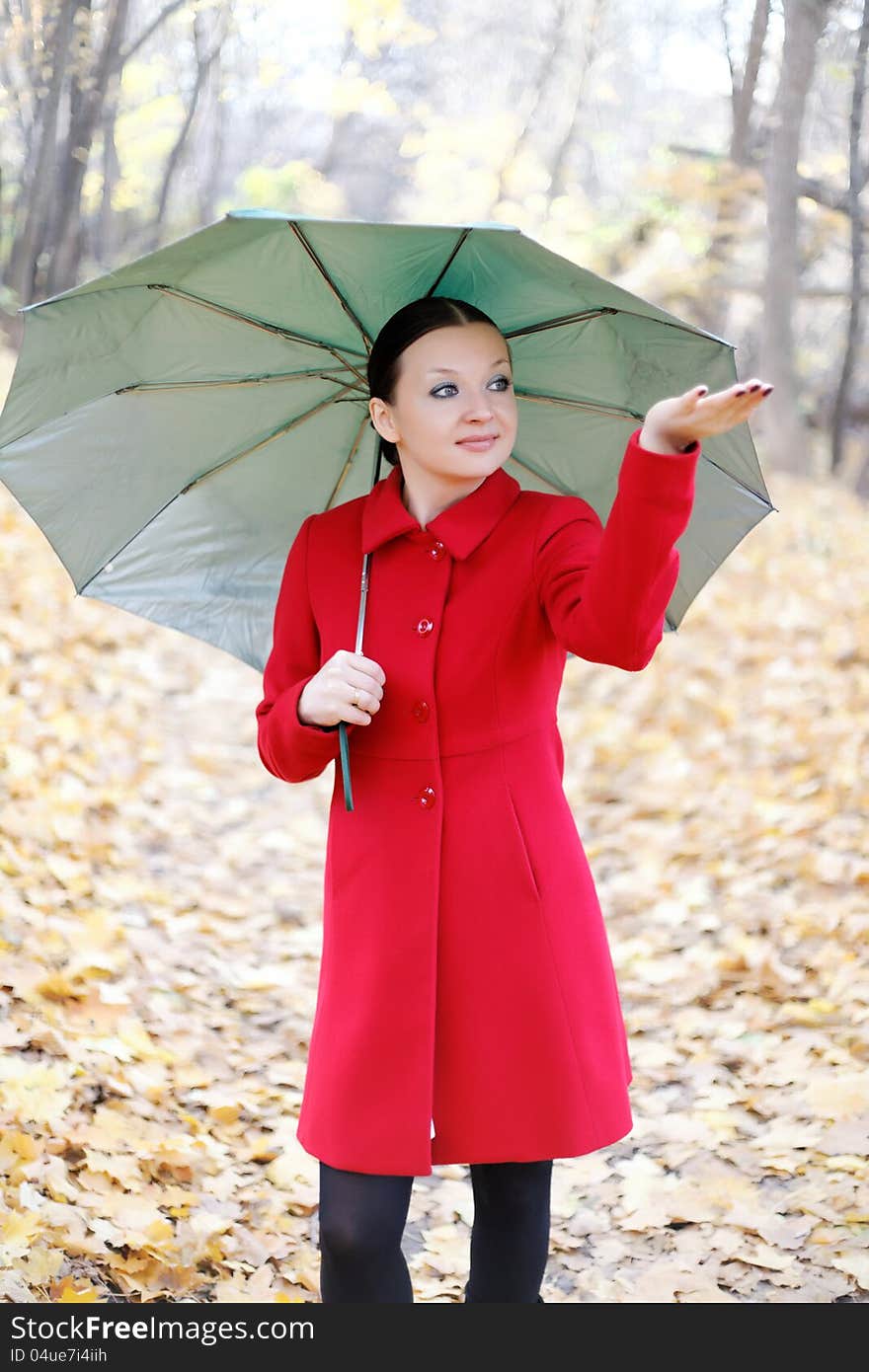 Girl in the autumn forest with umbrella