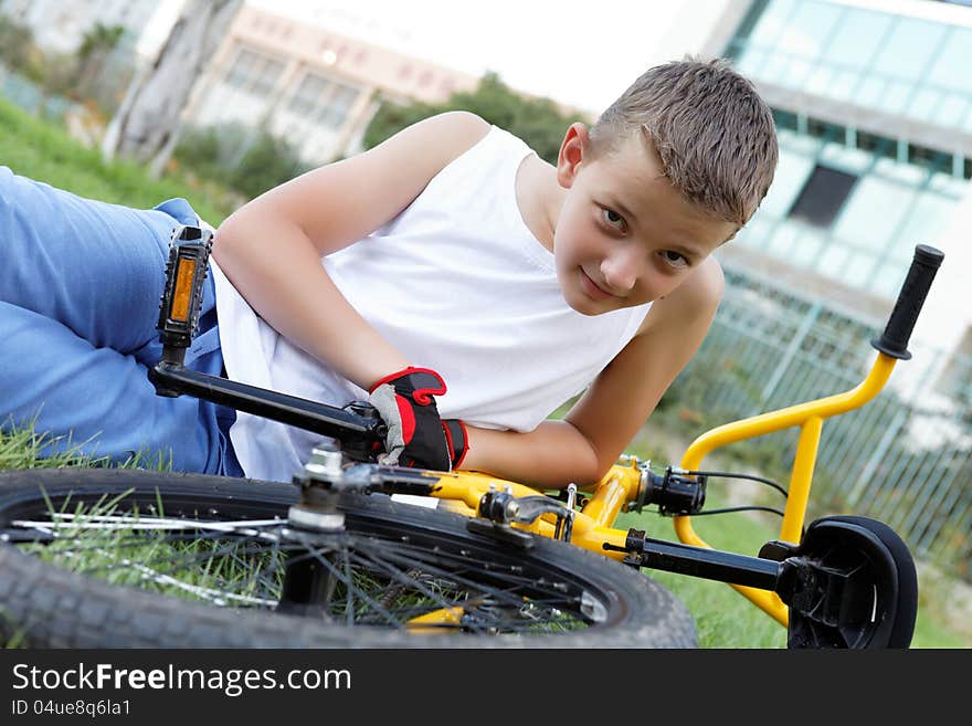 Cute boy with his bicycle outside in the afternoon