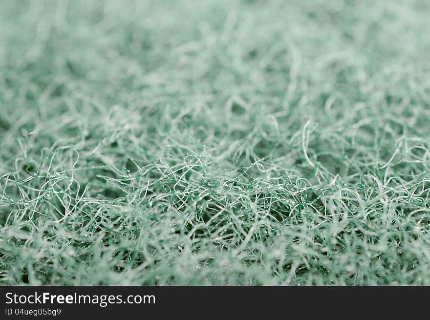 A super macro shot of green scrubbing sponge texture. A super macro shot of green scrubbing sponge texture