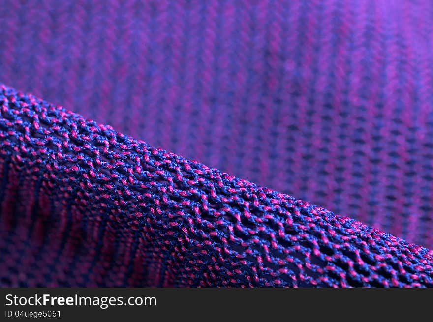 A super macro shot of pink and purple fabric texture. A super macro shot of pink and purple fabric texture