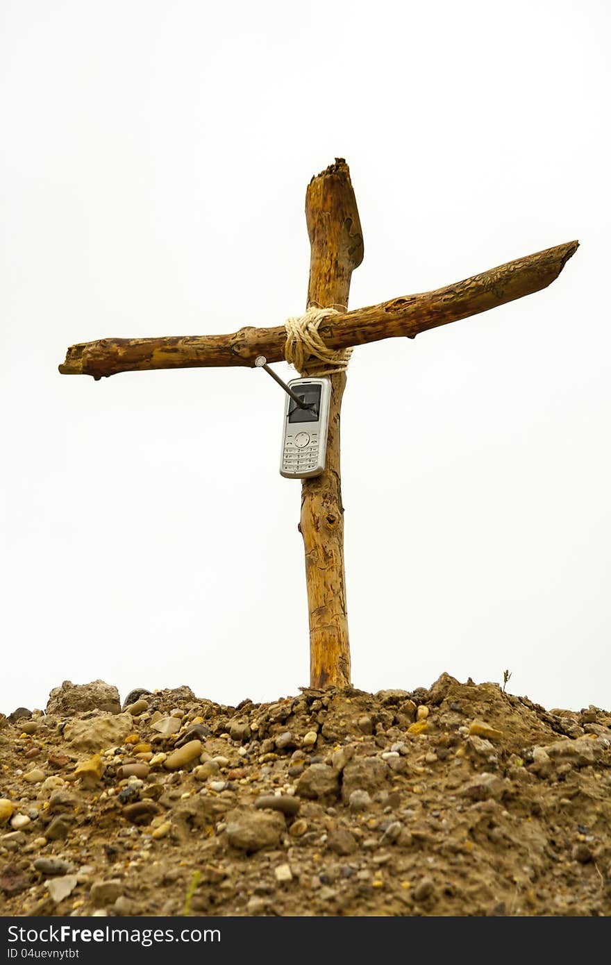 Cell phone nailed on wooden cross on mountain, isolated on white. Cell phone nailed on wooden cross on mountain, isolated on white.