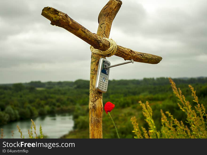 Cell phone nailed on wooden cross. Cell phone nailed on wooden cross.