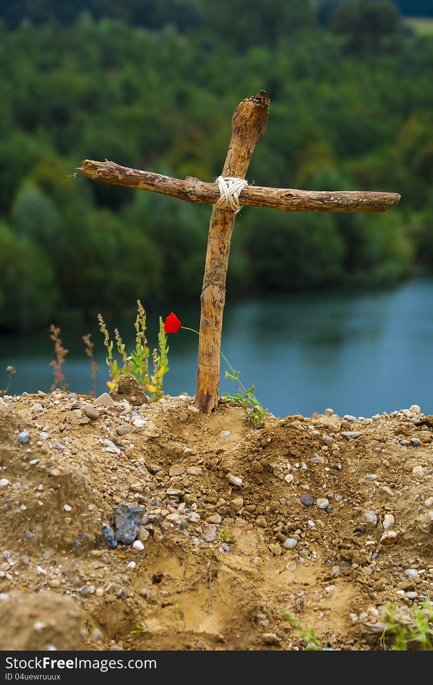 Wooden cross standing on hill top