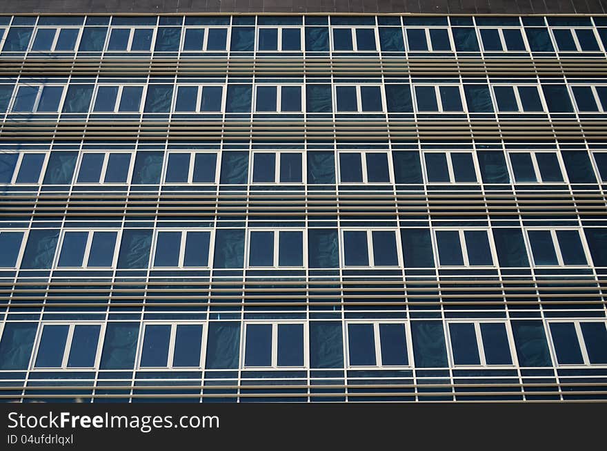 A large number of identical windows on a building wall