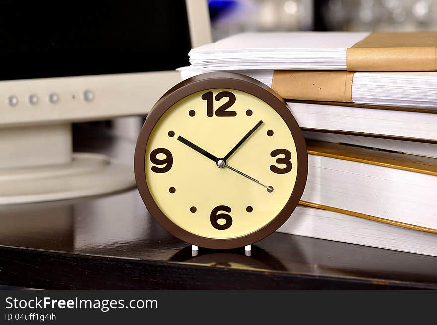 School time. Alarm clock and stack of books. Concept of education.