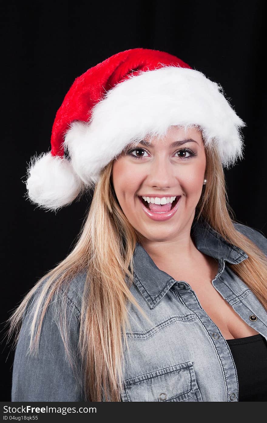 A portrait of a smiling, blond, Christmas Santa girl with red hat