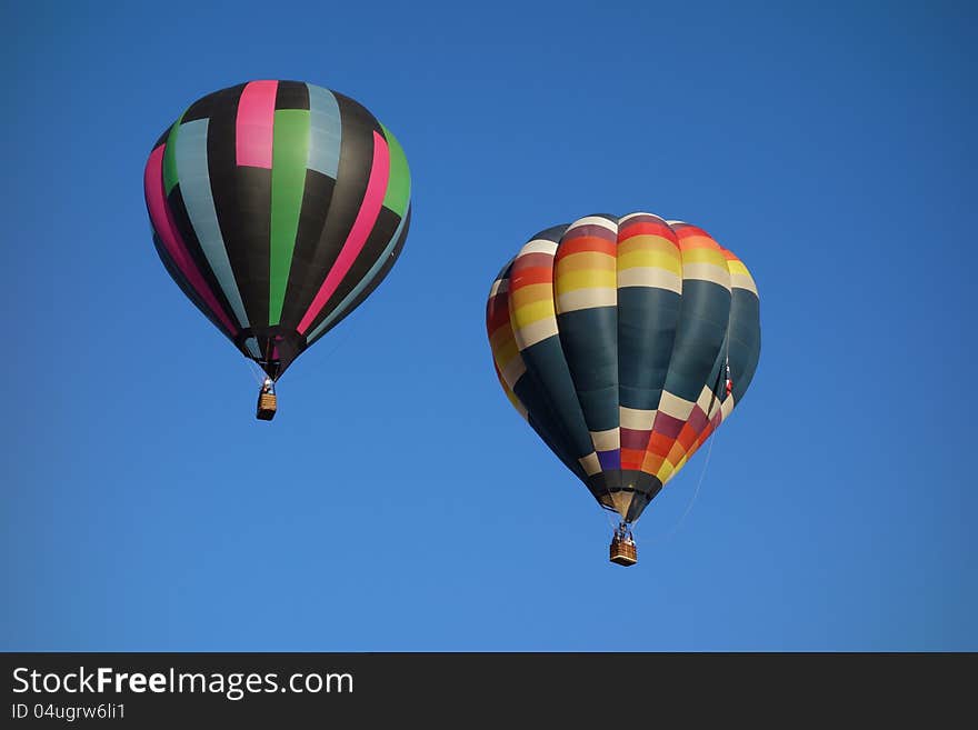 Square patterned hot air balloons, blue sky