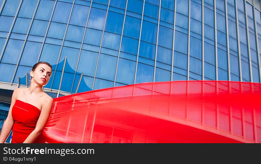 Young beautiful girl with the red in the city