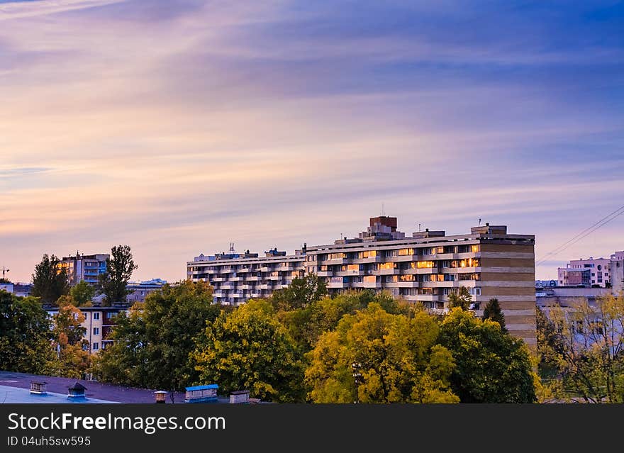 Buildings in a city in an environment of green trees. Buildings in a city in an environment of green trees