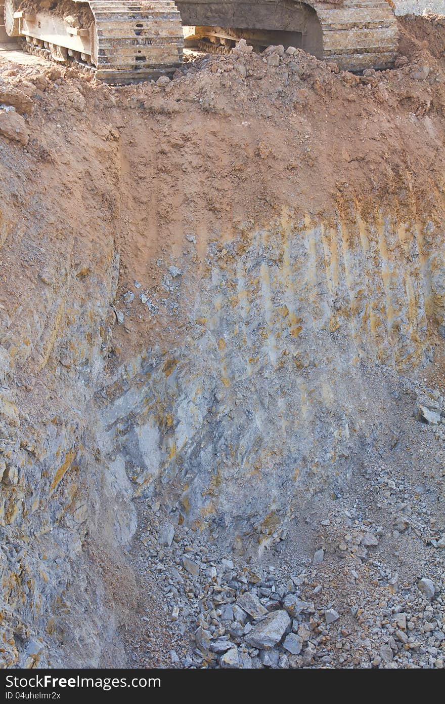 Caterpillar backhoe on the cliffs.