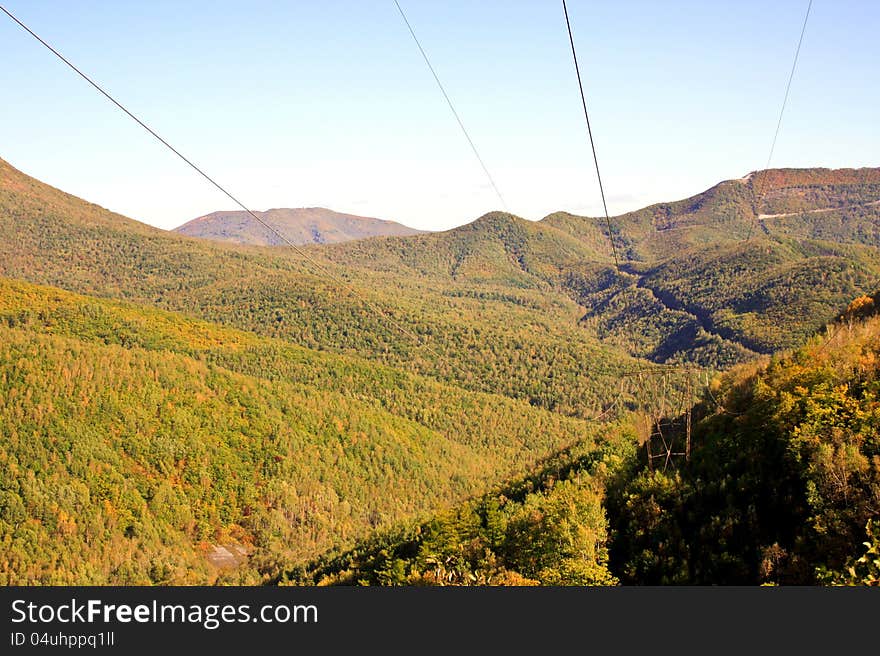 The high-voltage line passes on hillsides. The high-voltage line passes on hillsides