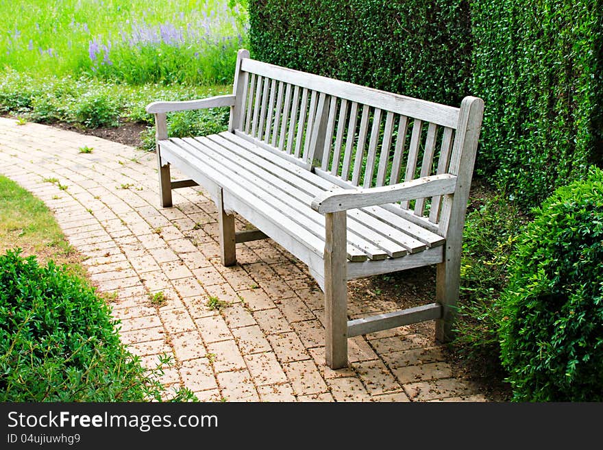 Wooden bench in a beautiful park garden. Wooden bench in a beautiful park garden