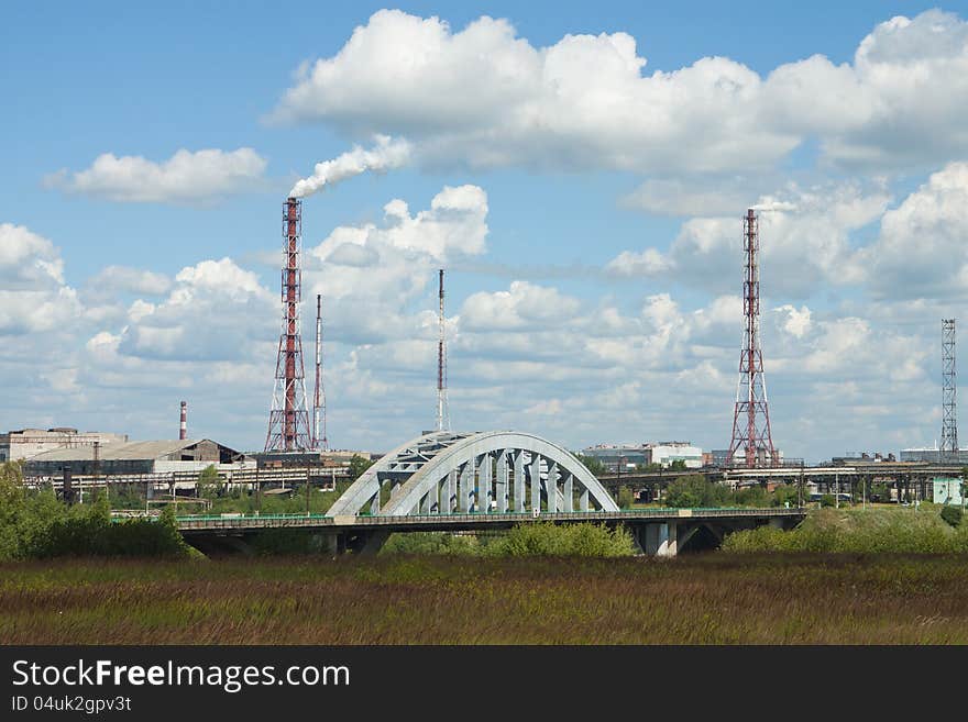 Pollutions of chemical plant pipes on blue sky with clouds background