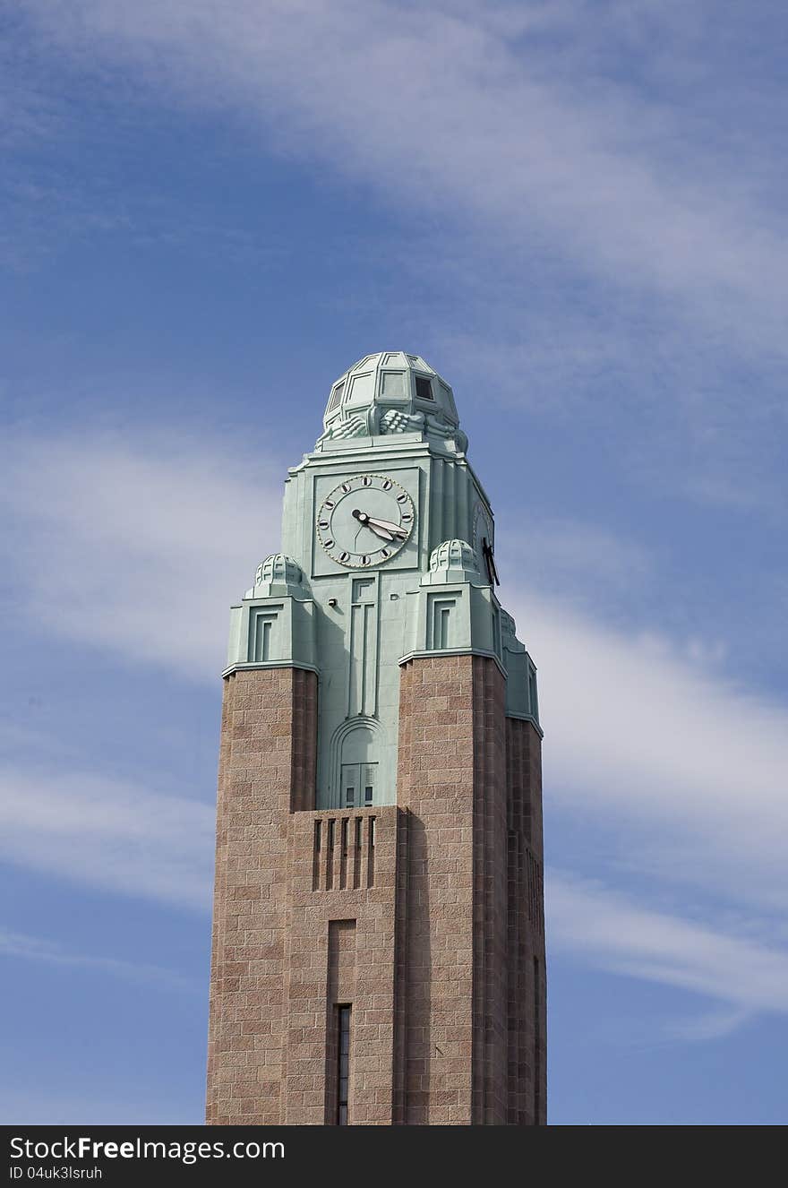 Clock tower Helsinki unde a blue sky with some clouds