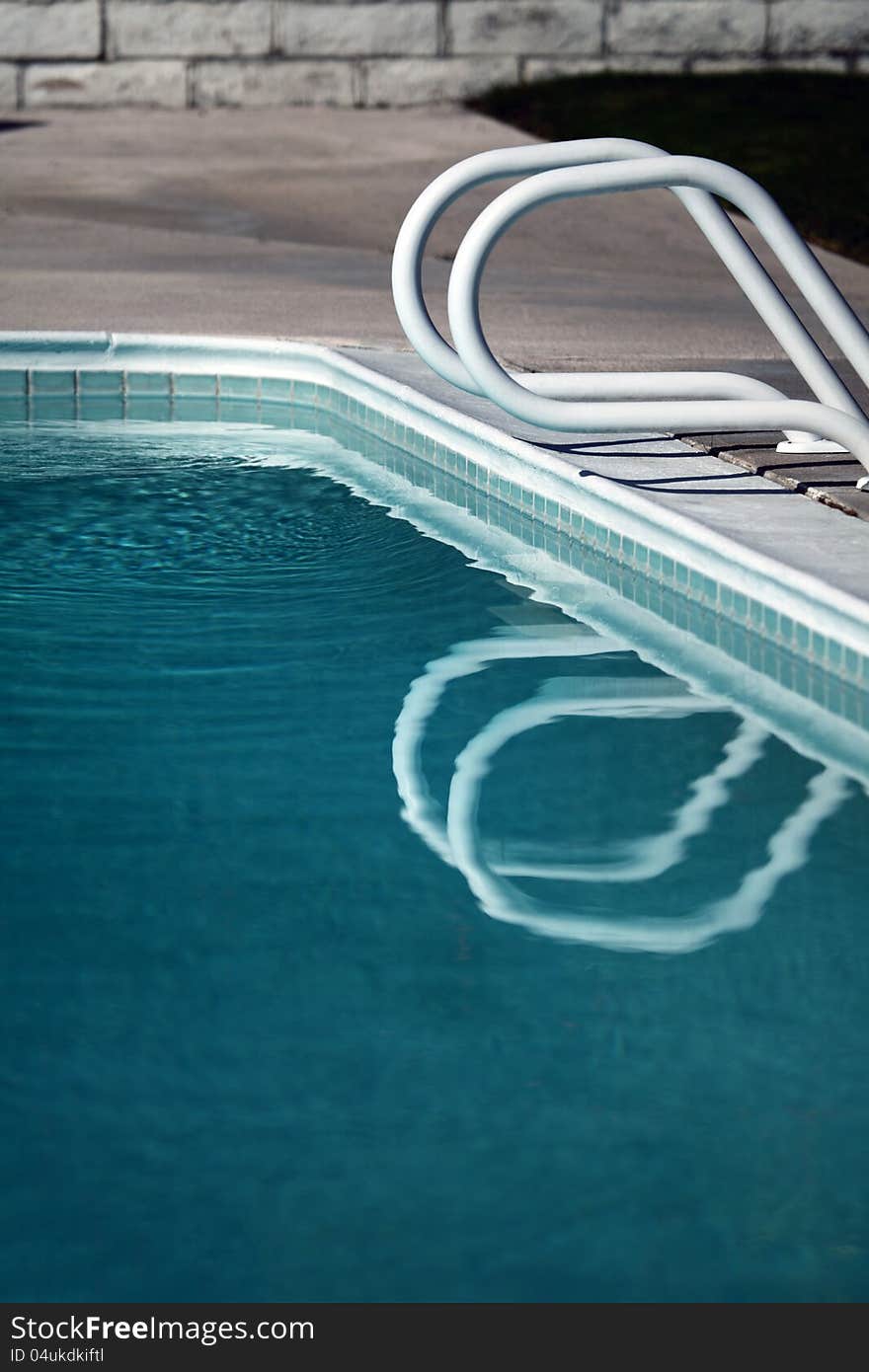 Swimming pool railing and reflection in water. Swimming pool railing and reflection in water