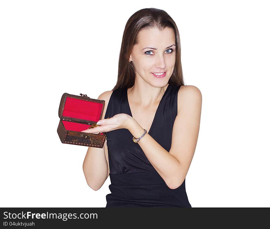 The beautiful young woman puts coins in a small, antiquarian chest. Separately on a white background. The beautiful young woman puts coins in a small, antiquarian chest. Separately on a white background