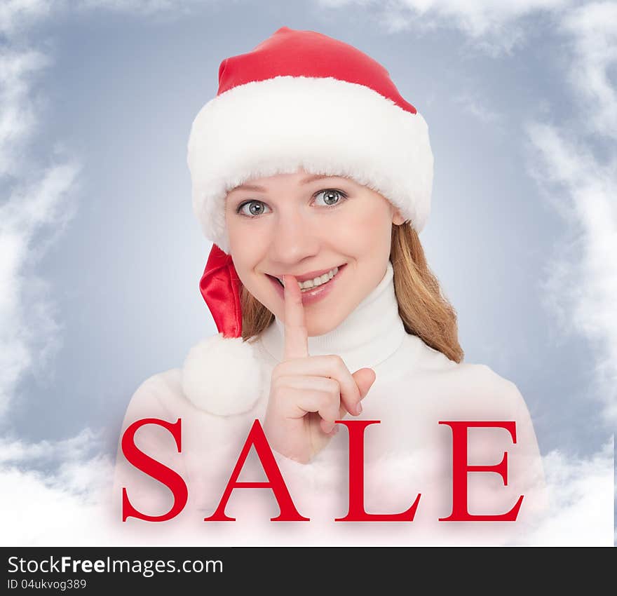 Christmas Sale and happy young woman in a Santa hat