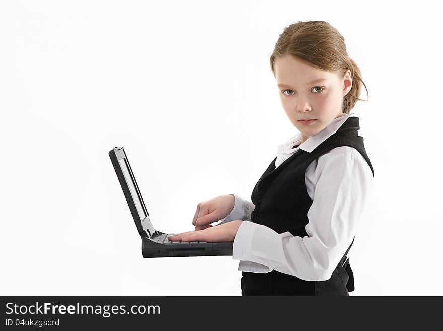 Girl with the computer in the school dress. Girl with the computer in the school dress