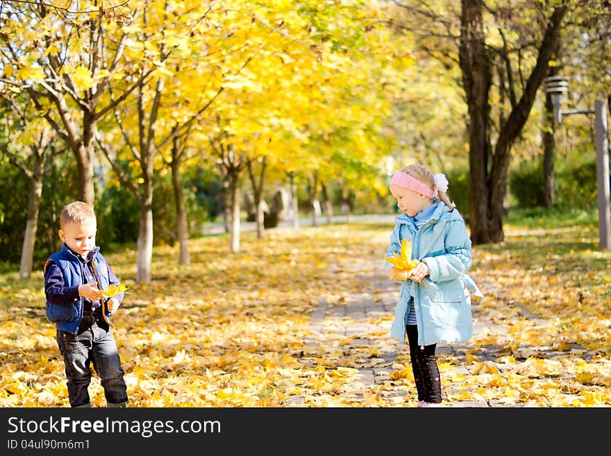 Children In A Colourful Autumn Park