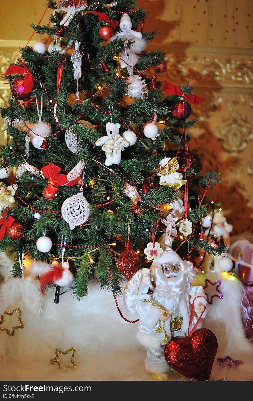 Under the Christmas tree is decorated with toys, santa claus in a white suit