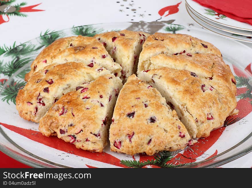 Sliced cranberry nut scone on a glass platter. Sliced cranberry nut scone on a glass platter