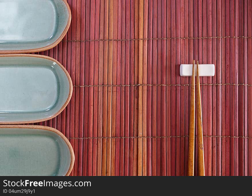 Chopsticks and plate mat  in asian set table. Chopsticks and plate mat  in asian set table