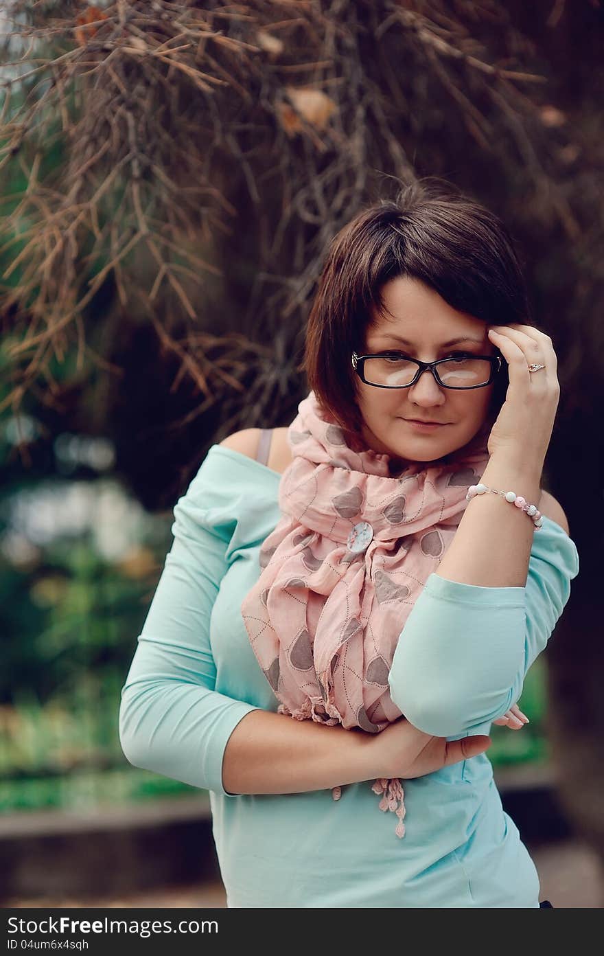 Portrait of a woman posing in a blue sweater and glasses. Portrait of a woman posing in a blue sweater and glasses