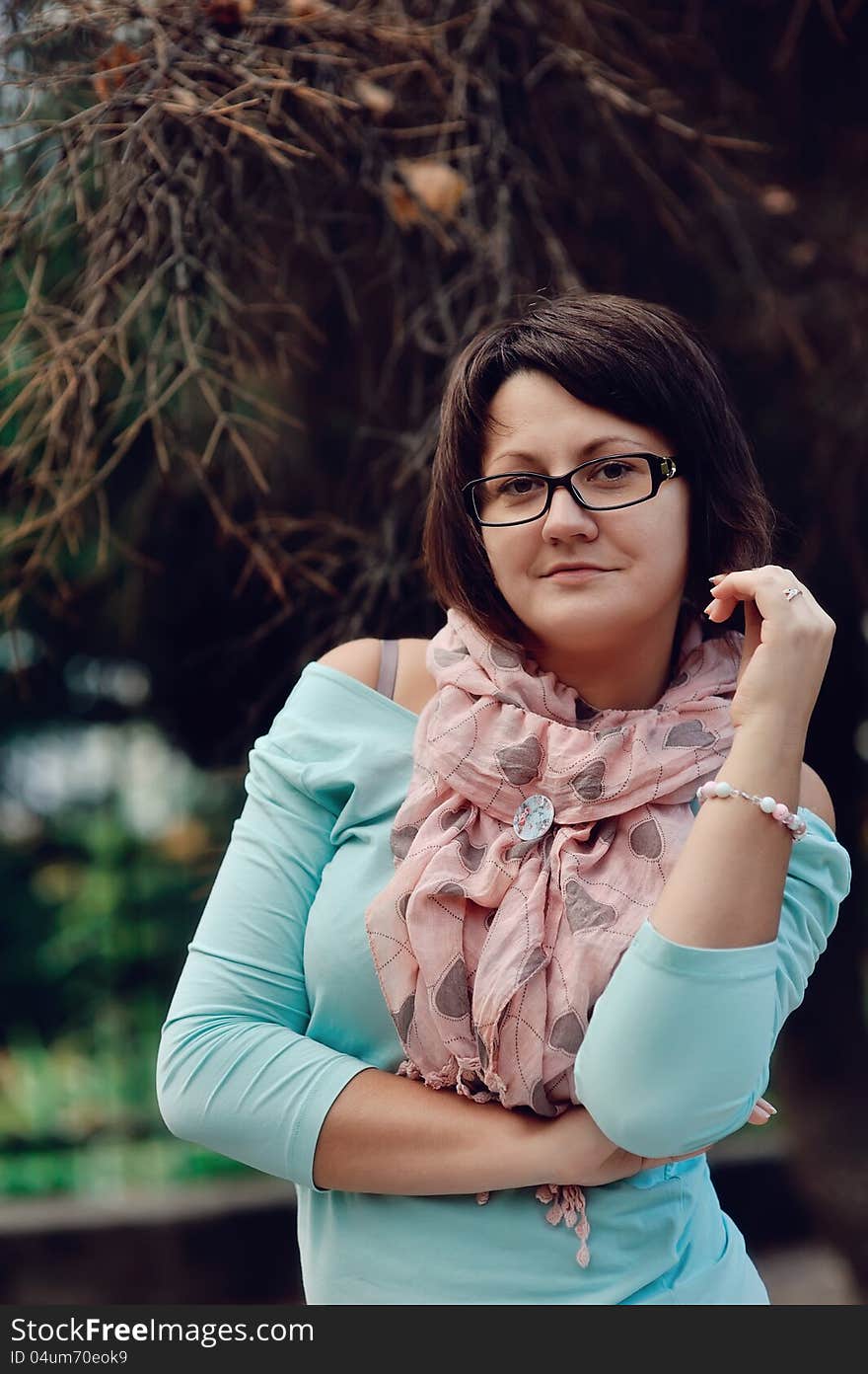 Portrait of a woman posing in a blue sweater and glasses. Portrait of a woman posing in a blue sweater and glasses