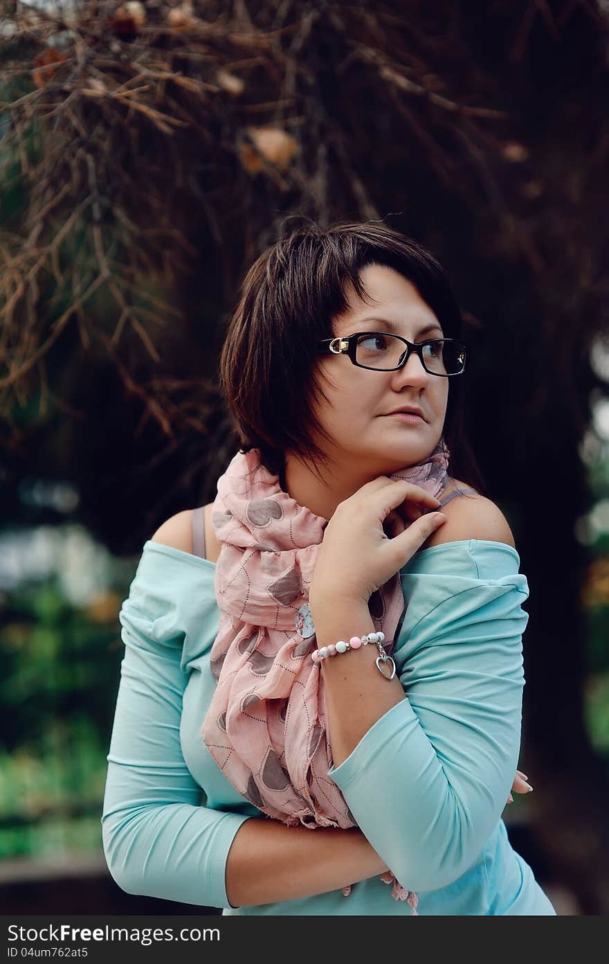 Portrait of a woman posing in a blue sweater and glasses. Portrait of a woman posing in a blue sweater and glasses