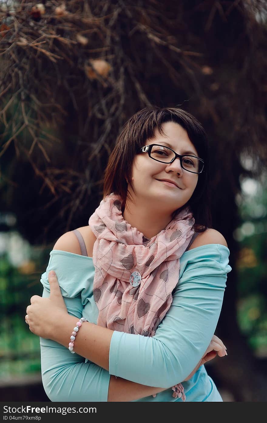 Portrait of a woman posing in a blue sweater and glasses. Portrait of a woman posing in a blue sweater and glasses