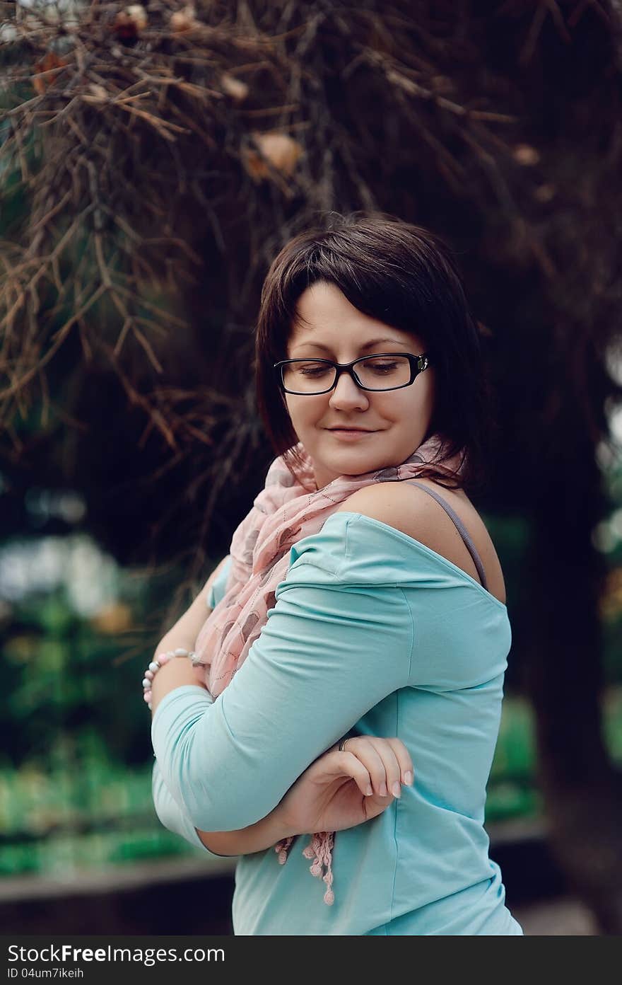 Portrait of a woman posing in a blue sweater and glasses. Portrait of a woman posing in a blue sweater and glasses